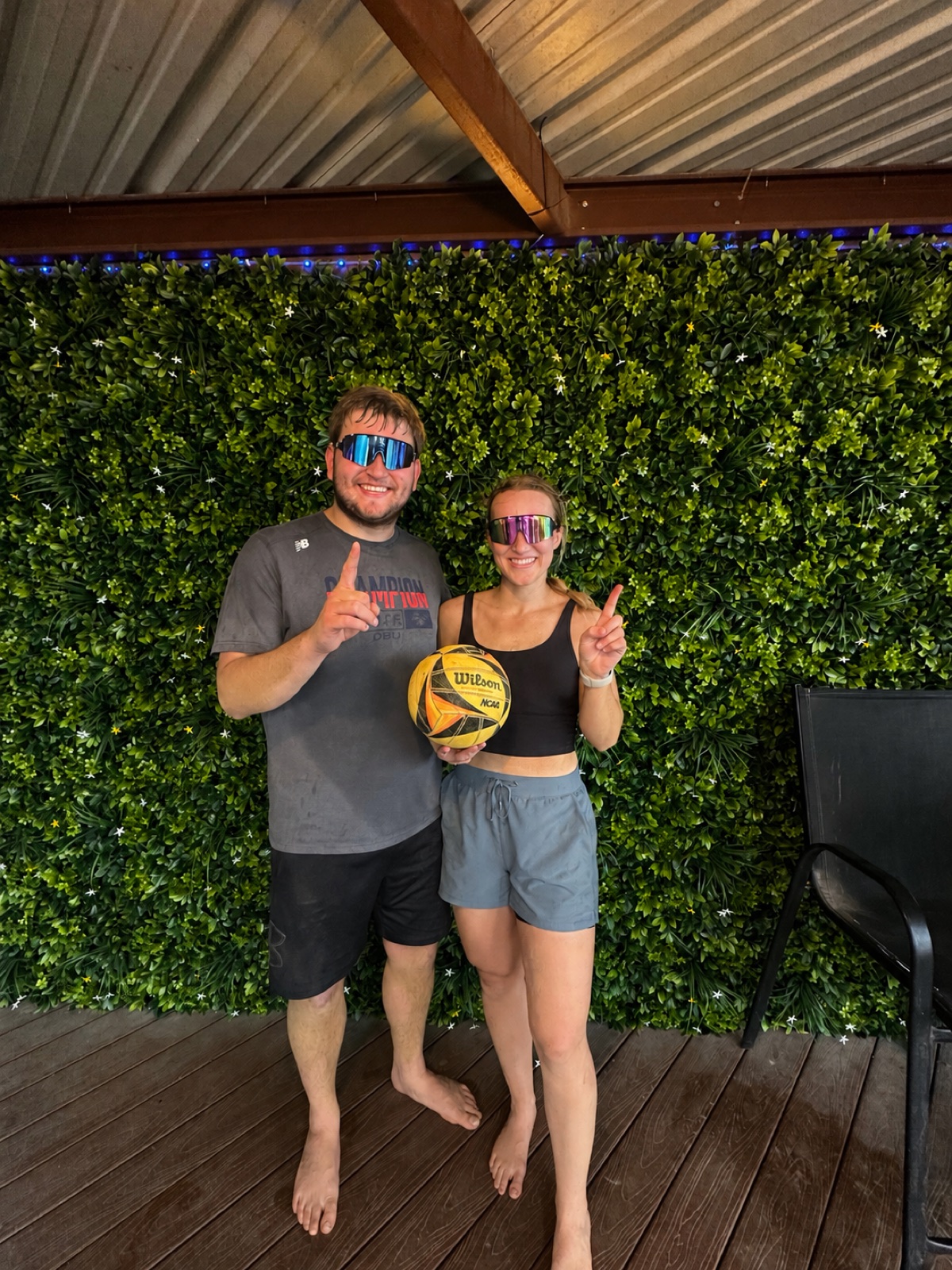 Carson Oberkrom and Melissa holding a volleyball after playing sand volleyball
